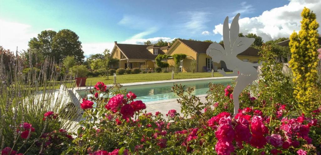 una casa con piscina y flores en Le Clos des 4 Saisons, en La Rochepot