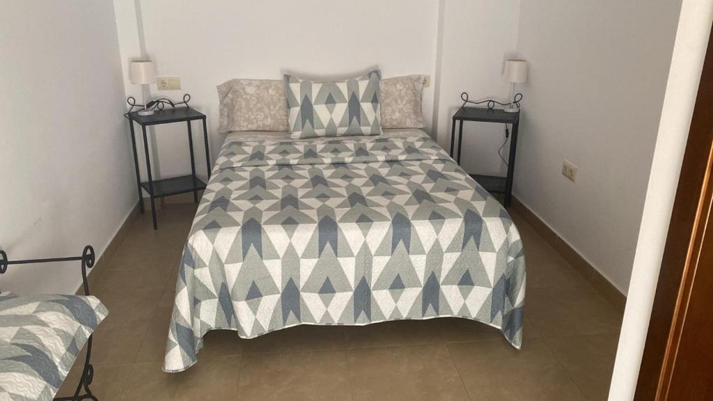 A bed or beds in a room at Apartamentos Centro El Rompido