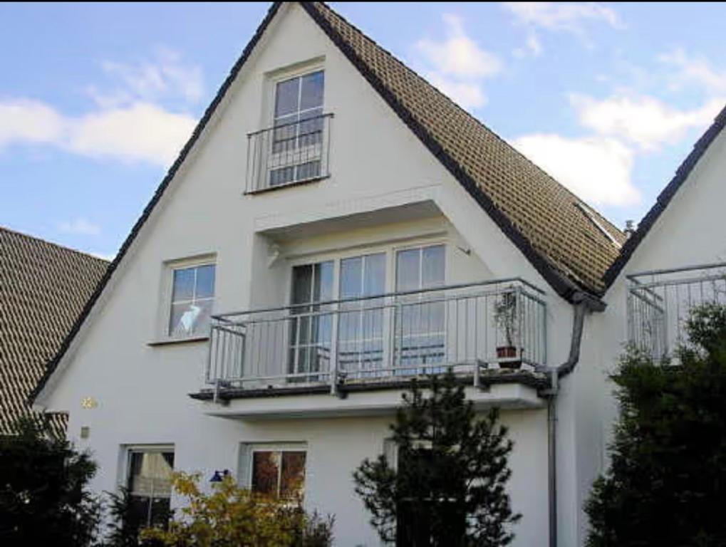 a white house with balconies on the side of it at Ferienwohnung Frische Brise in Drewoldke