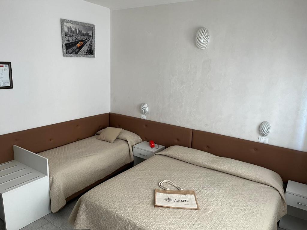 Postel nebo postele na pokoji v ubytování Hotel Touring
