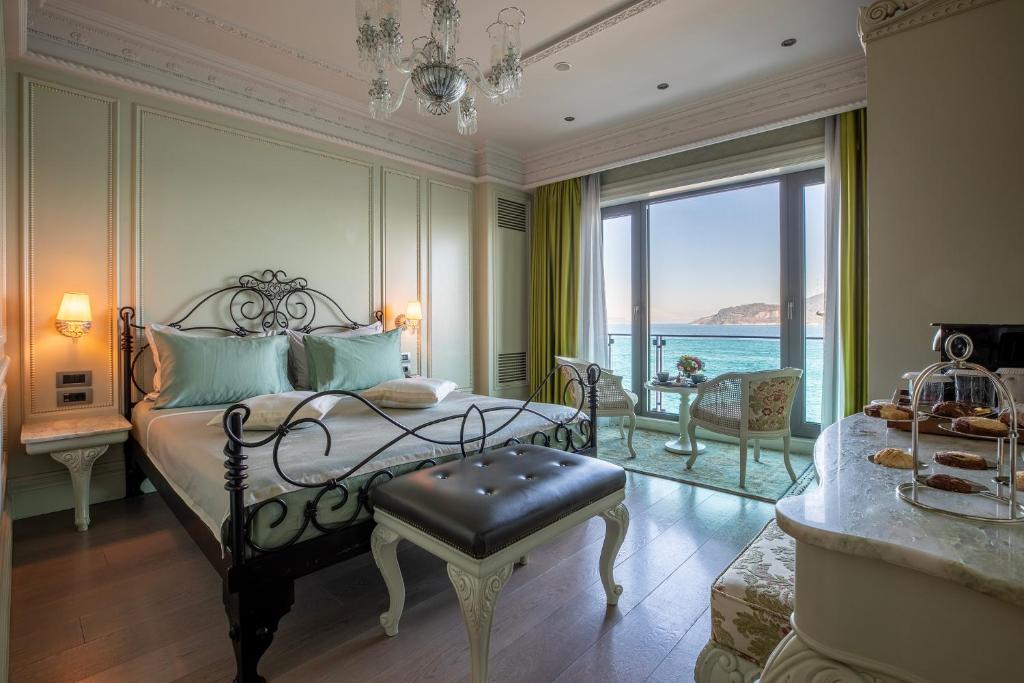 a bedroom with a bed with a view of the ocean at MFB Tarabya Hotel in Istanbul