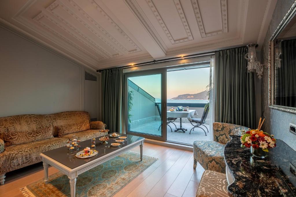 a living room with a couch and a table at MFB Tarabya Hotel in Istanbul