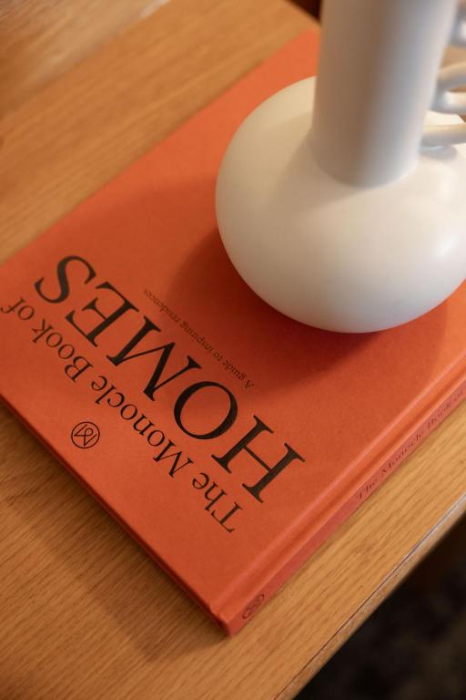 a book on a table with a cup on top of it at St Giles London – A St Giles Hotel in London