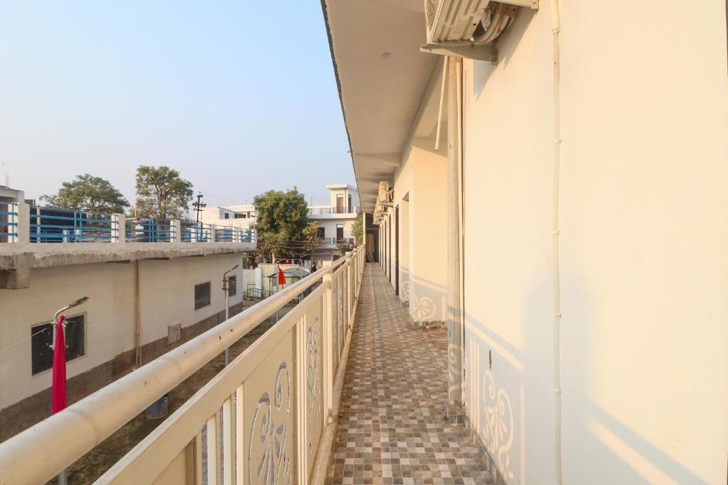 a corridor of an apartment building with a balcony at OYO Flagship Metro Inn in Chinhat