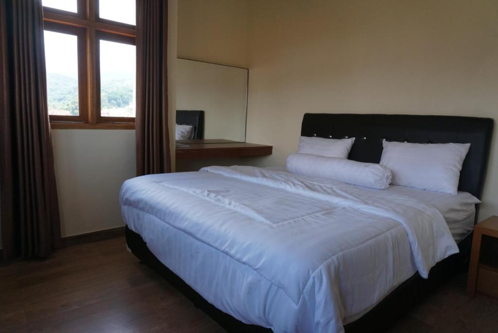 Postel nebo postele na pokoji v ubytování Cipada Guesthouse syariah