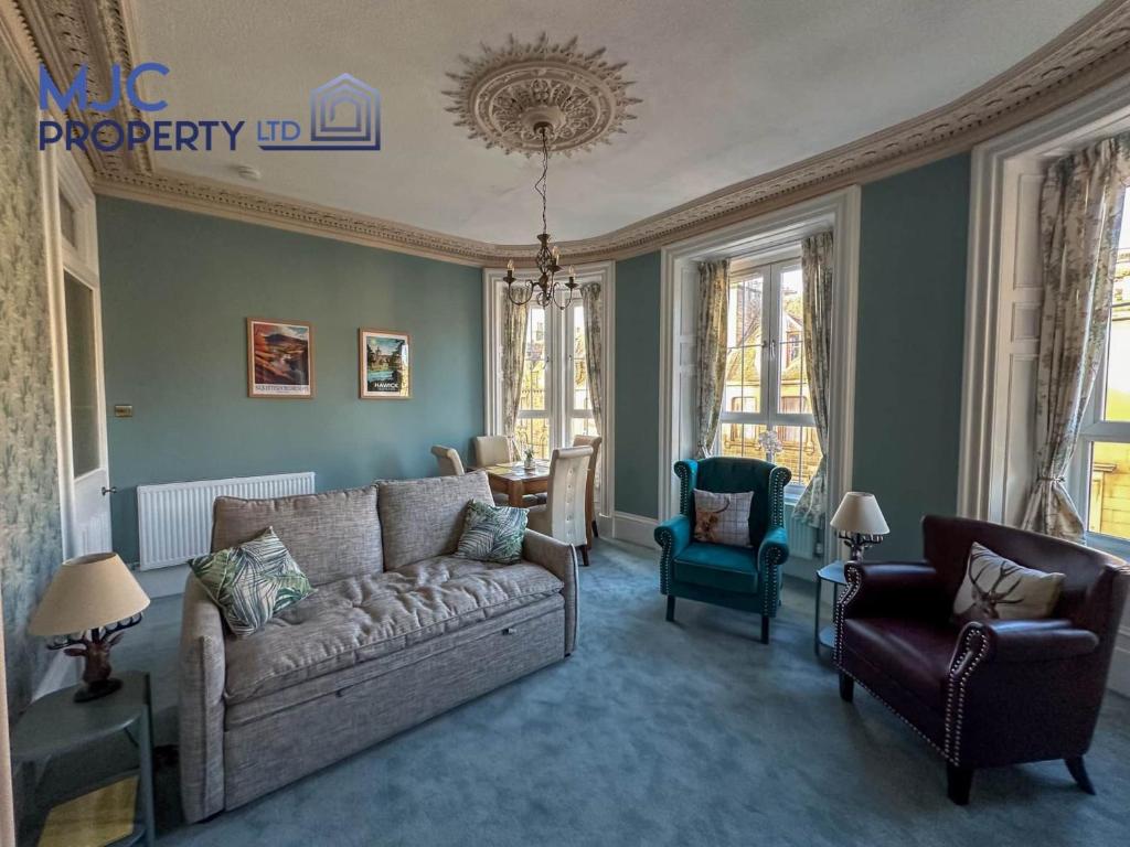 a living room with a couch and a chair at Cross Wynd Apartment in Hawick