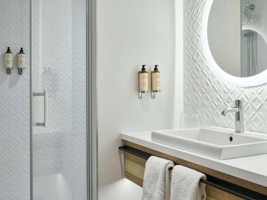 bagno con lavandino e specchio di Mercure Hôtel Le Touquet a Le Touquet-Paris-Plage