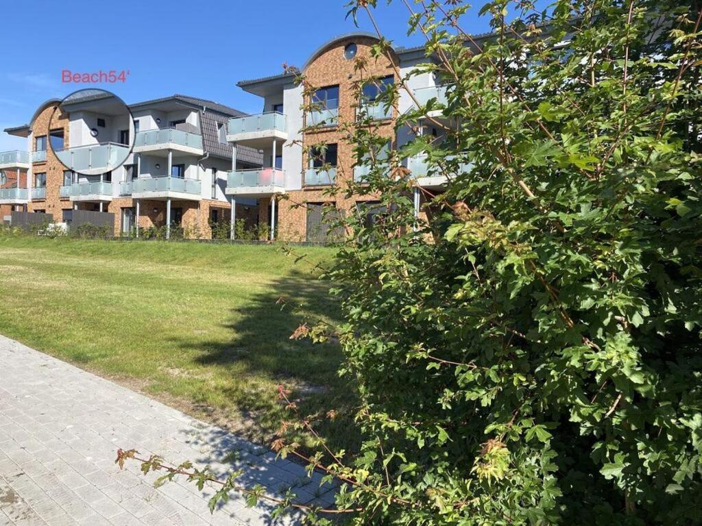 a large building with a tree in front of it at Holiday apartment Beach54´Damp in Damp