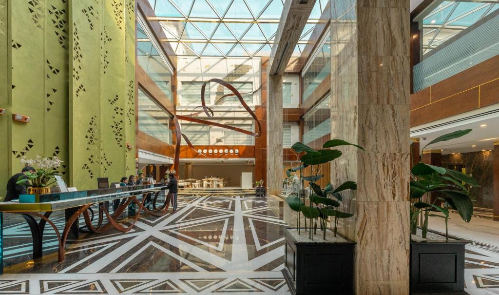 a lobby of a building with a glass ceiling at Best Western Premier Islamabad in Islamabad