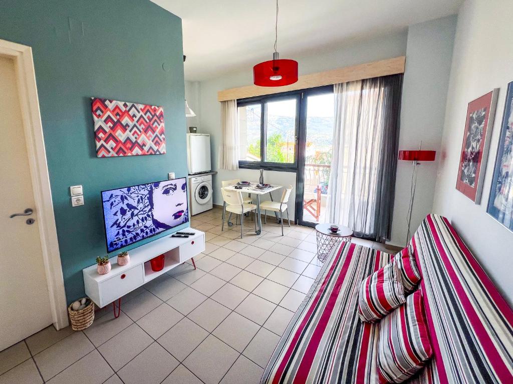 a living room with a television and a dining room at CityZEN View - Retro Nest in Argostoli