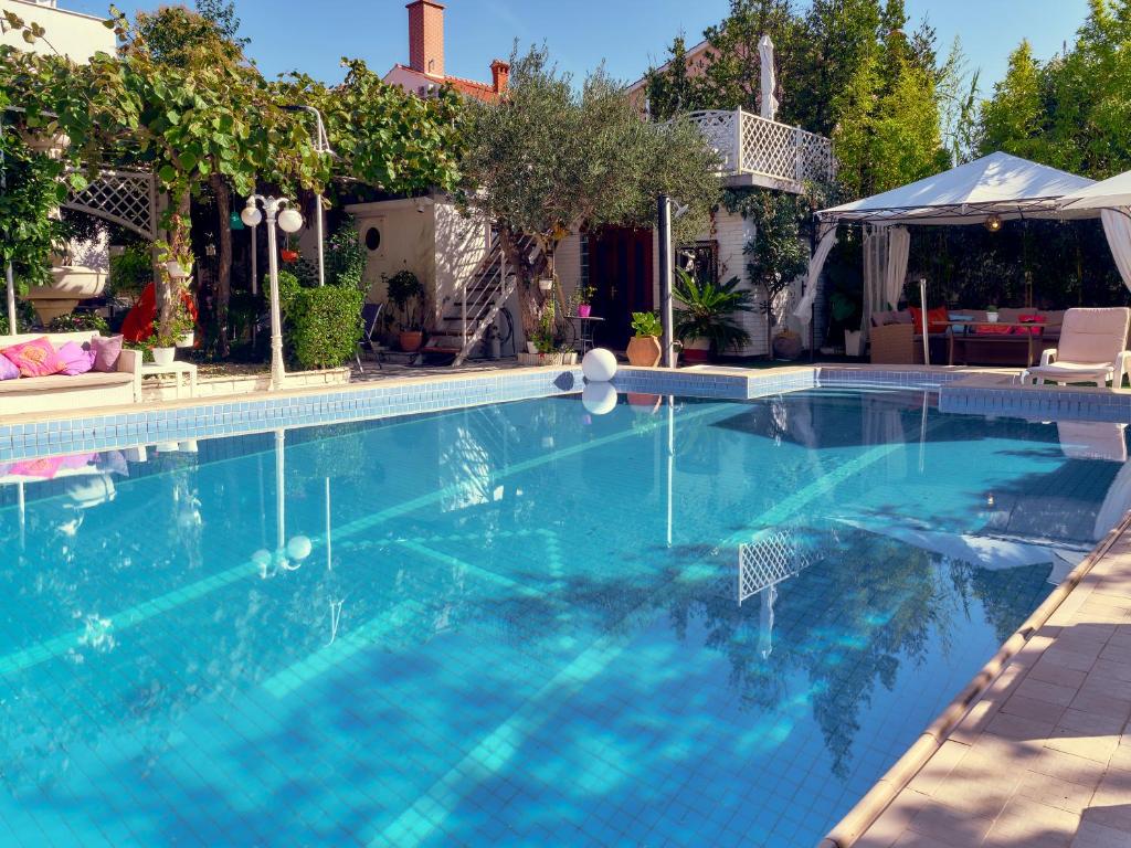 a large swimming pool with blue water at Guest House Villa Ines - Annex in Zadar
