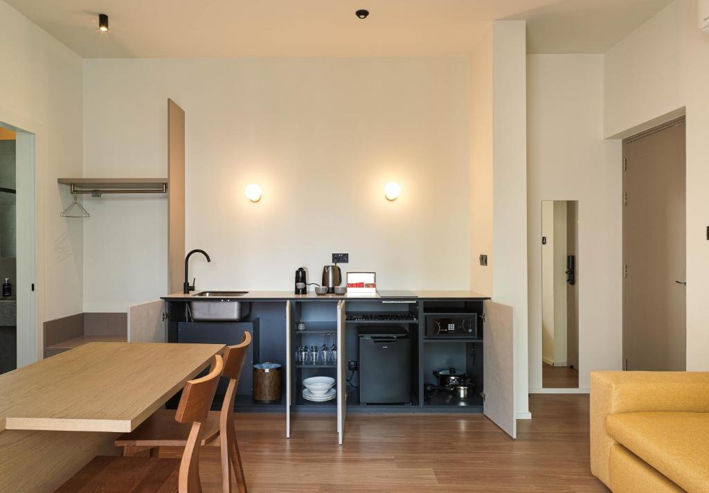 a kitchen with a table and a dining room at Alinea Market Agora Square in Limassol