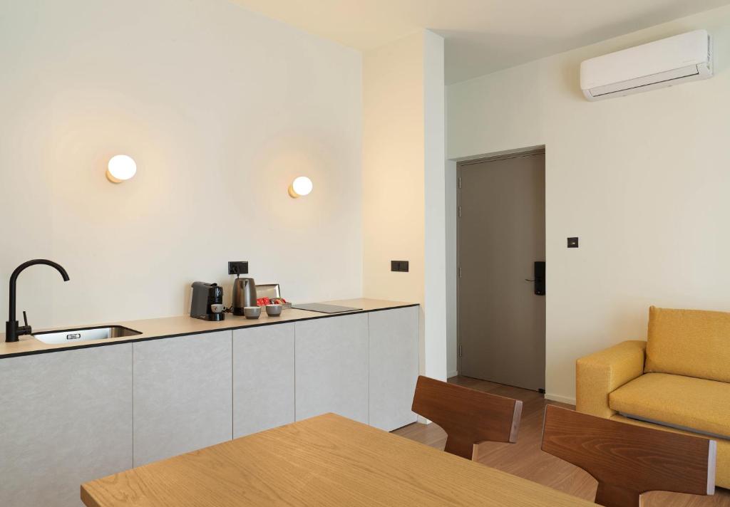 a kitchen with a counter and a chair in a room at Alinea Market Agora Square in Limassol
