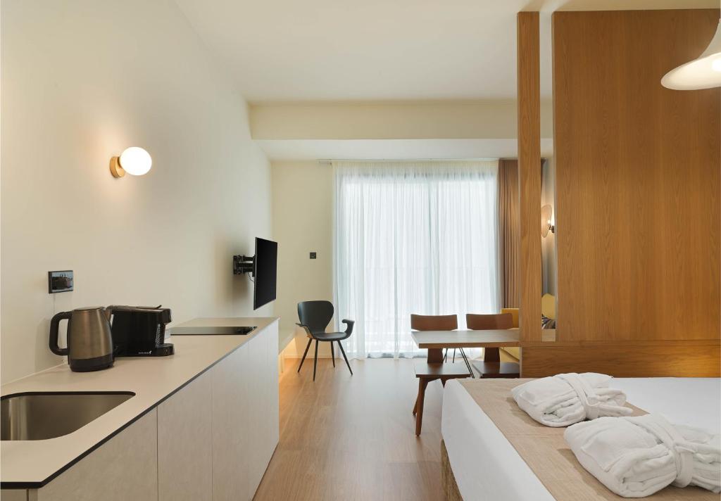 a kitchen and living room with a bed and a table at Alinea Market Agora Square in Limassol