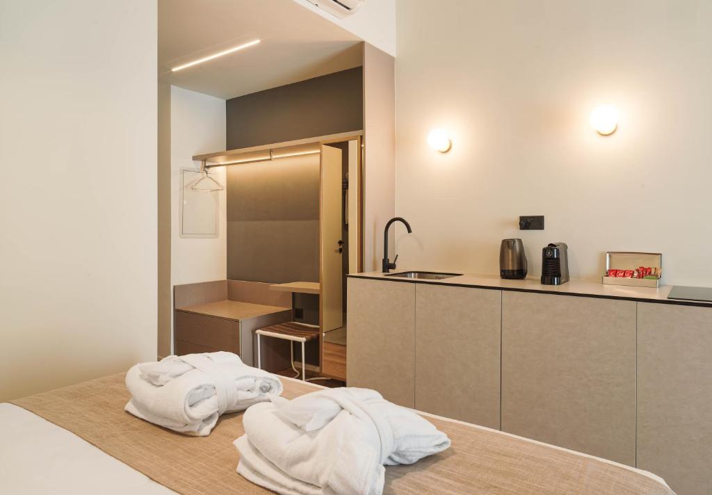 a kitchen with white towels sitting on a table at Alinea Market Agora Square in Limassol