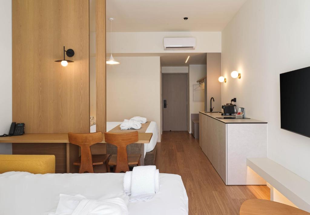 a room with a bed and a table and a kitchen at Alinea Market Agora Square in Limassol