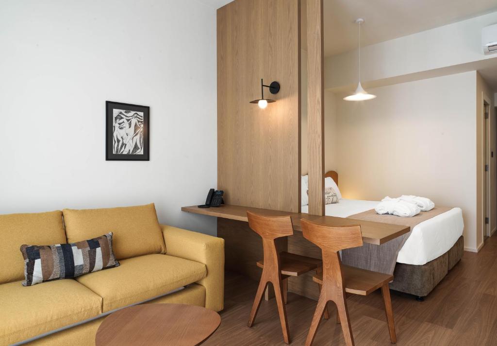 a room with a couch and a table and a bed at Alinea Market Agora Square in Limassol