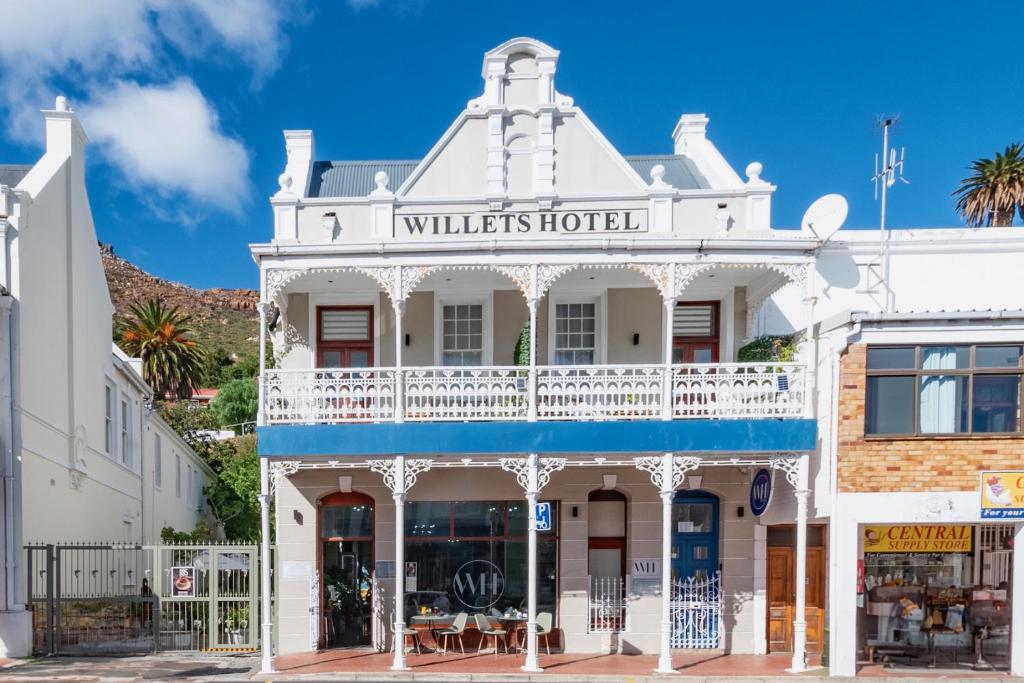 a white building with a sign that reads williates hotel at Willets Hotel in the heart of Simon's Town in Simonʼs Town