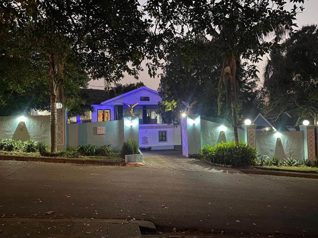 a house is lit up at night with lights at Caribe Accommodation and Conferences in Pietermaritzburg