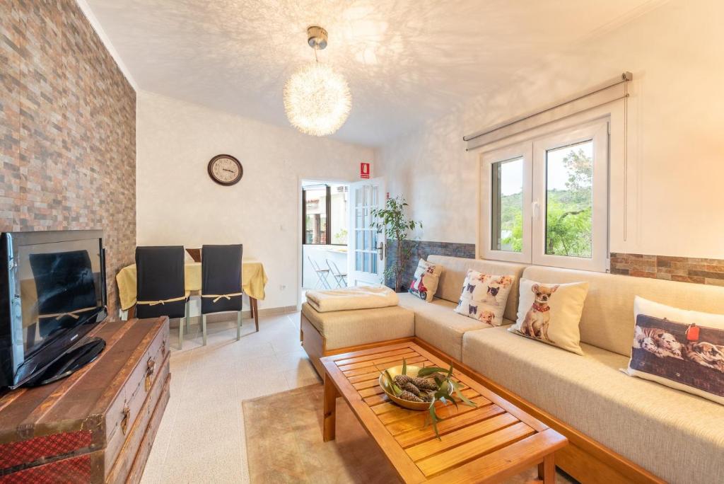 a living room with a couch and a table at Countryside paradise in Bucelas in Bucelas