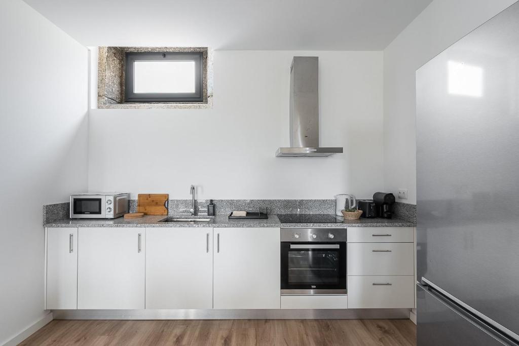 A cozinha ou cozinha compacta de GuestReady - Casas de Fralães 1