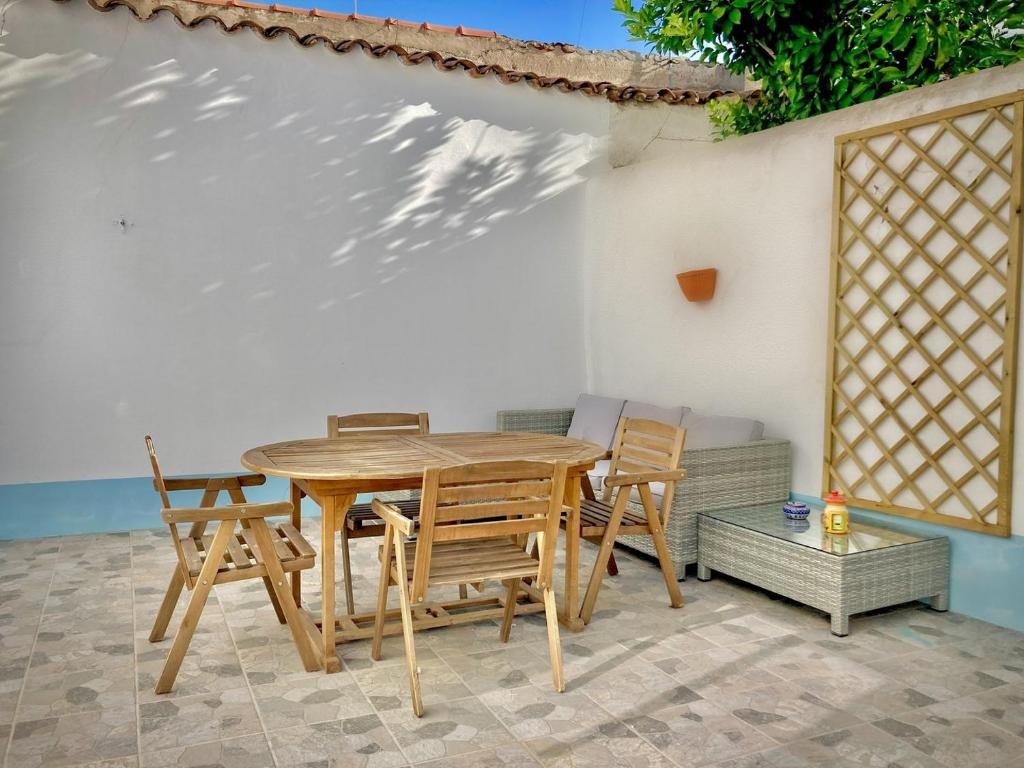 a wooden table and chairs on a patio at Sunny respite in Evora in Reguengos de Monsaraz
