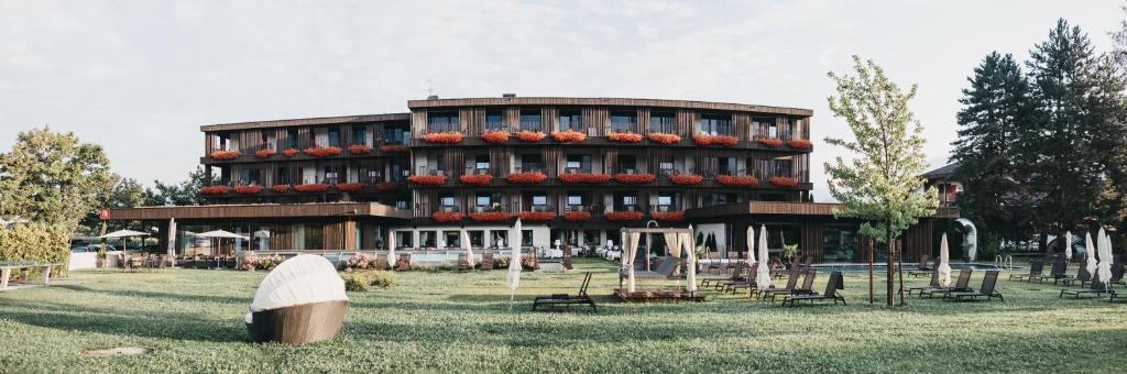 a building with a lot of flowers in front of it at Hotel Rudolf in Brunico