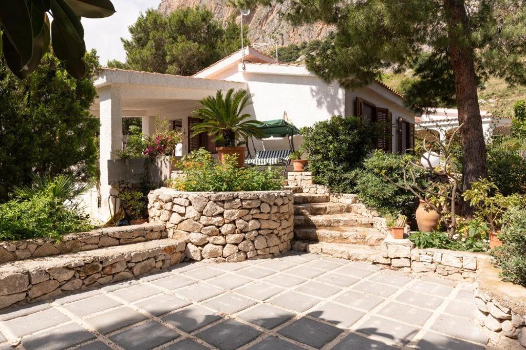 a house with a stone wall and a patio at Casa Vacanze Maria in San Vito lo Capo