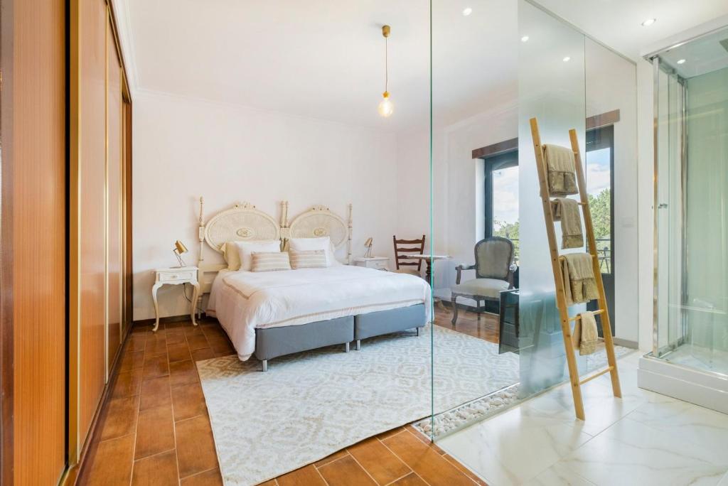a bedroom with a bed and a glass door at Vintage Charm Meets Modern Comfort 1 in Aguda