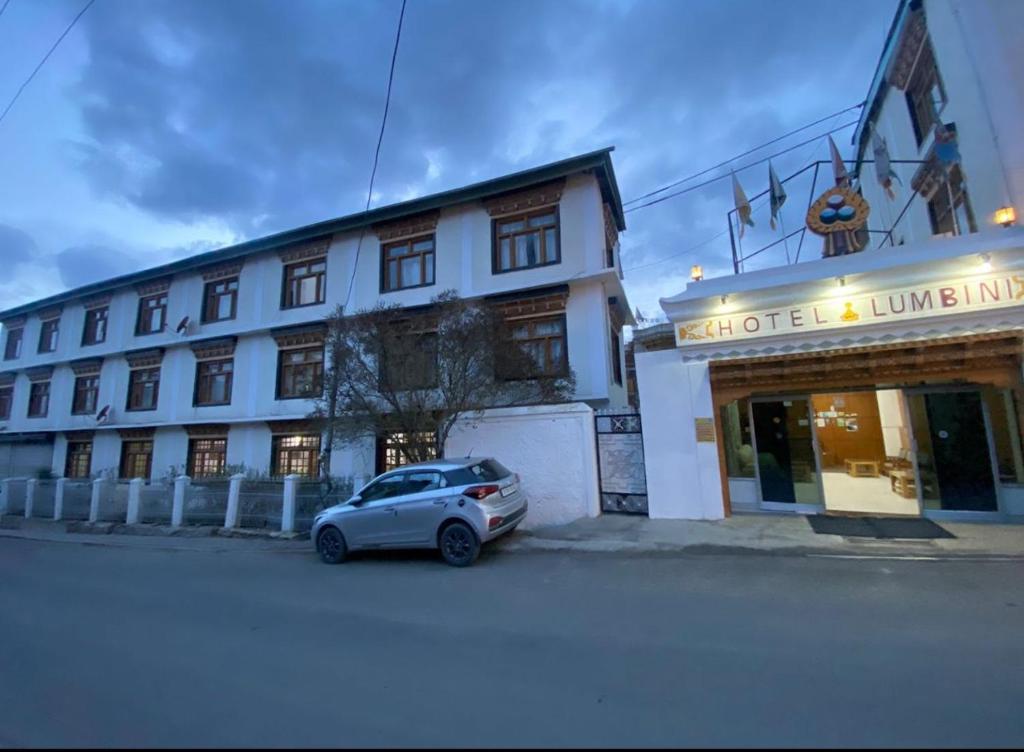 a small car parked in front of a building at Hotel Lumbini in Leh