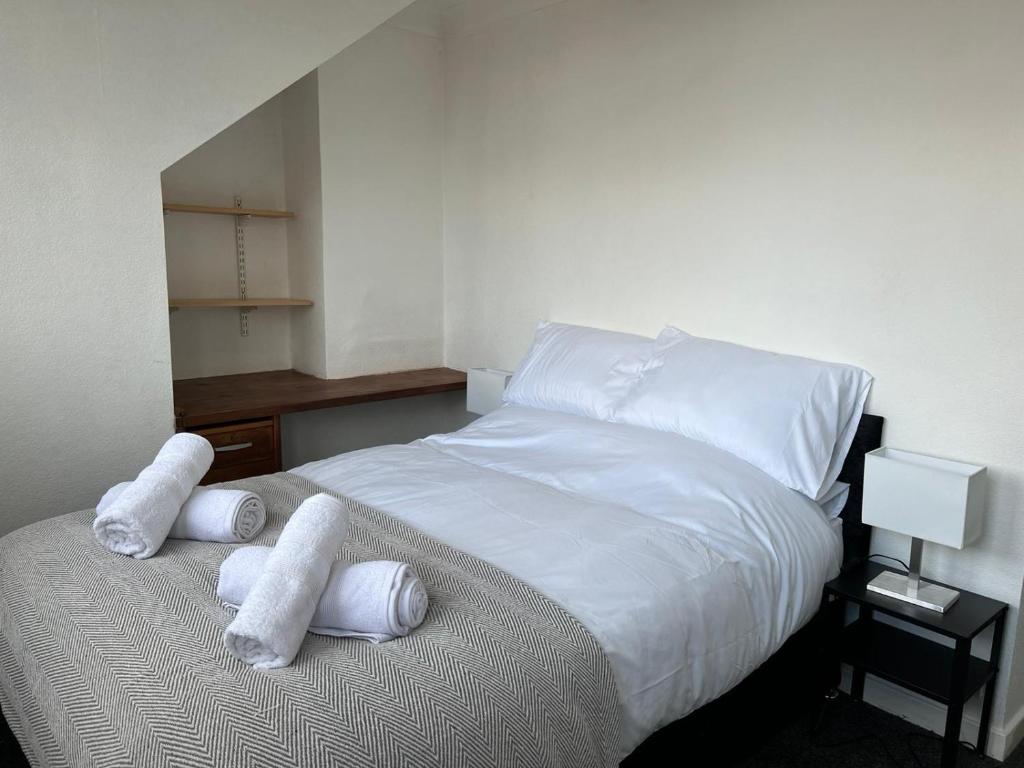 a bedroom with a bed with towels on it at Private flat close to Sunderland centre in Pallion