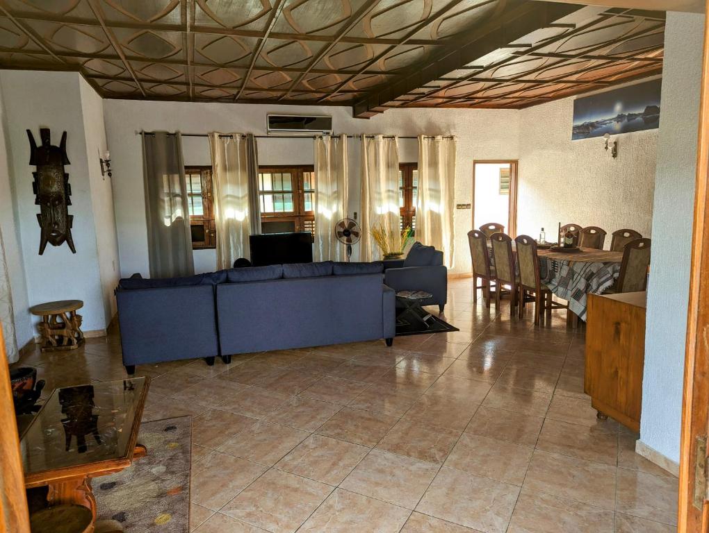 a living room with a blue couch and a table at ROMO house in Cotonou