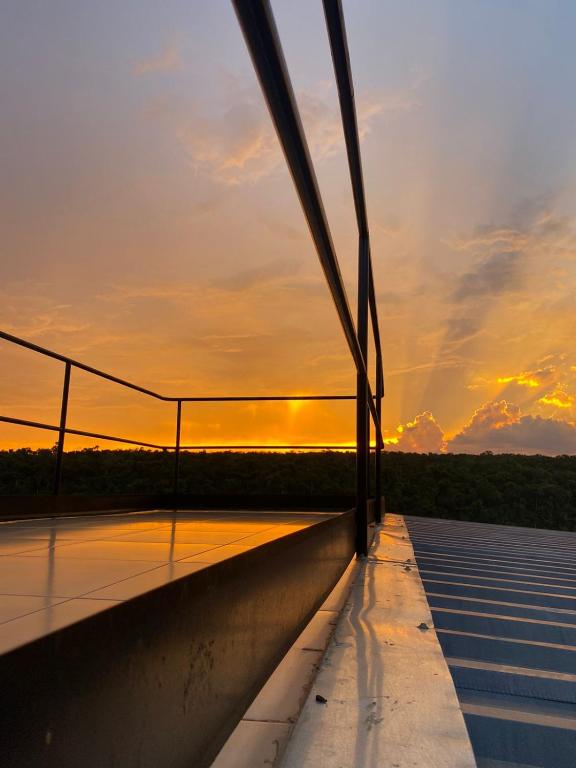 a view from the top of a bridge at sunset at Container Home Py in Puerto Presidente Franco