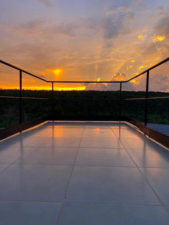 a view of the sunset from the balcony of a house at Container Home Py in Puerto Presidente Franco