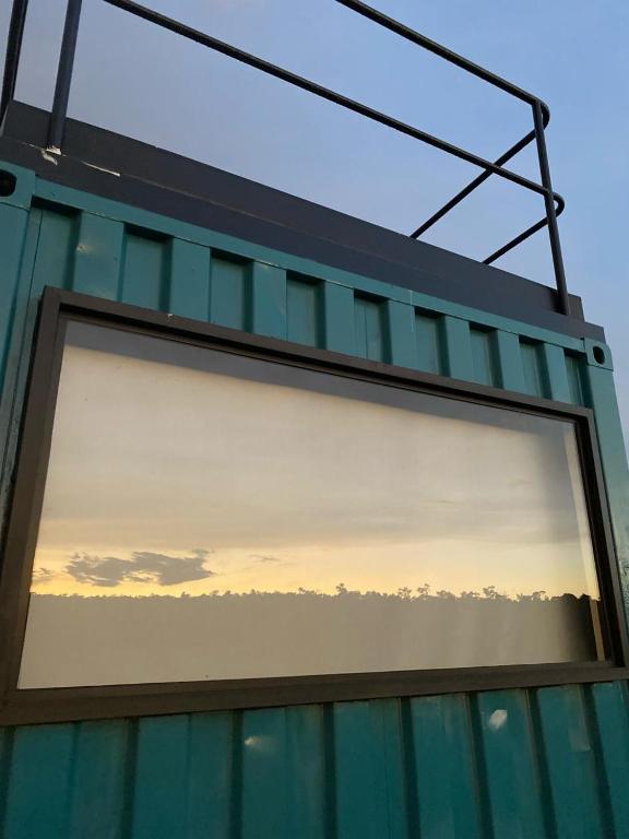 a window of a building with a sunset at Container Home Py in Puerto Presidente Franco