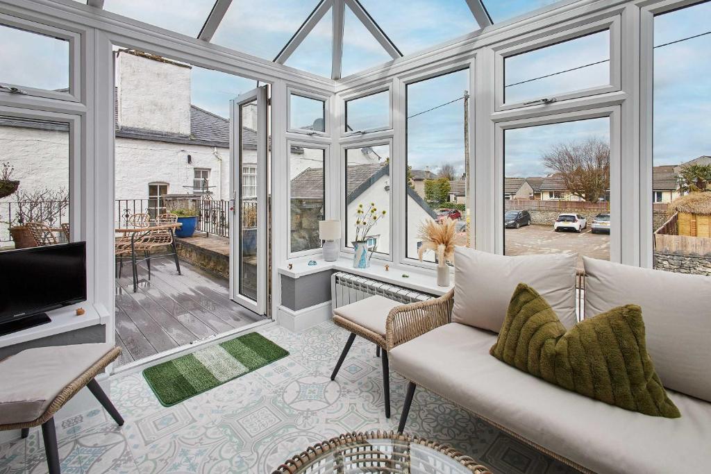 a living room with a lot of windows at Host & Stay - Lime Tree House in Holme