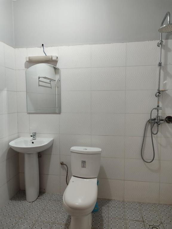 a bathroom with a toilet and a sink at HOTEL APPART B4U - BE FOR YOU in Yaoundé
