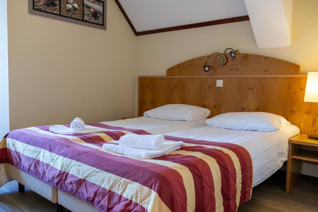 Postel nebo postele na pokoji v ubytování Hotel De Torenhoeve