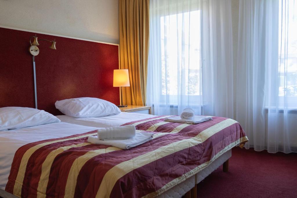 Postel nebo postele na pokoji v ubytování Hotel De Torenhoeve