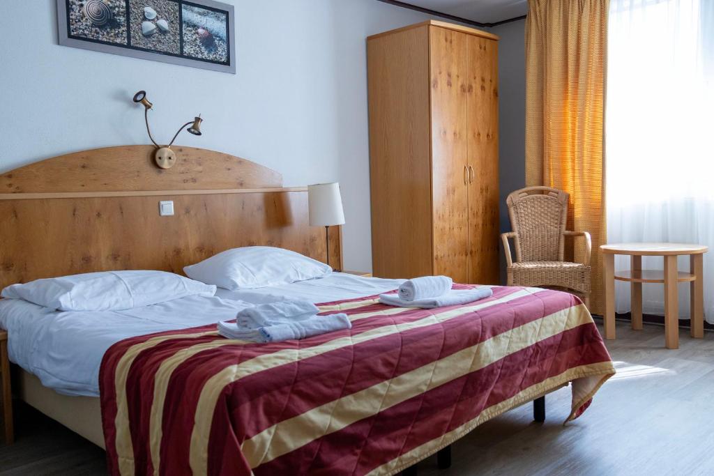 Postel nebo postele na pokoji v ubytování Hotel De Torenhoeve