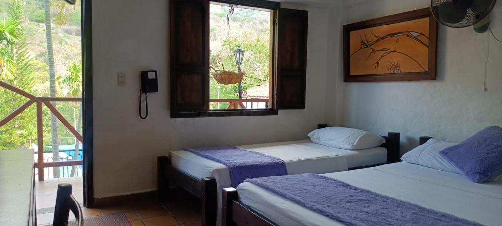 Postel nebo postele na pokoji v ubytování Hotel Verano Resort San Gil