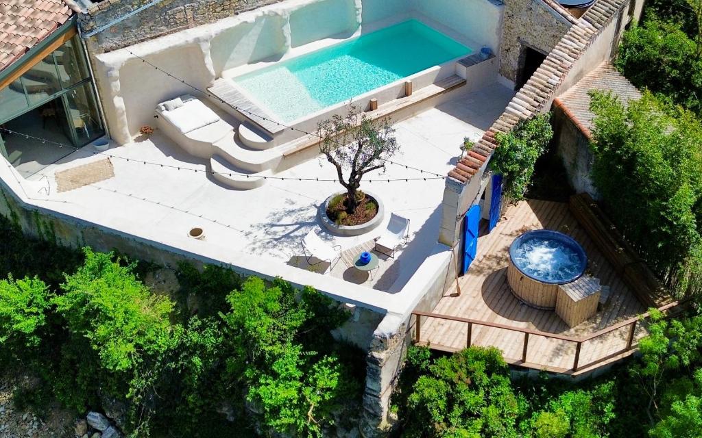 an overhead view of a house with a swimming pool at Les Terrasses de Bélarga - Maison d'hôtes - Piscine et Jacuzzi in Bélarga