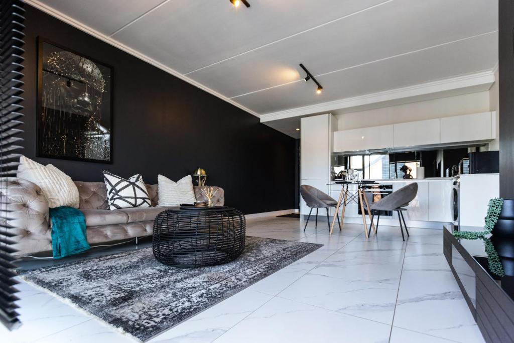a living room with a couch and a table at City Nest:Heart of Linksfield II in Johannesburg