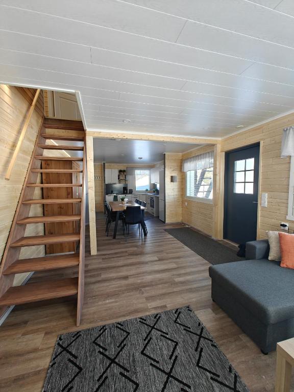 a living room with a staircase in a house at Aava Sky Village in Aavasaksa