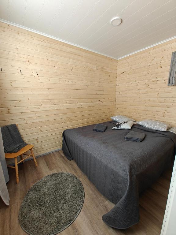 a bedroom with a bed and a chair at Aava Sky Village in Aavasaksa