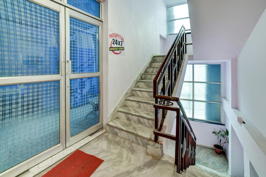 a staircase in a house with a window at OYO Flagship 83165 Hotel Om Shanti in Khagaul