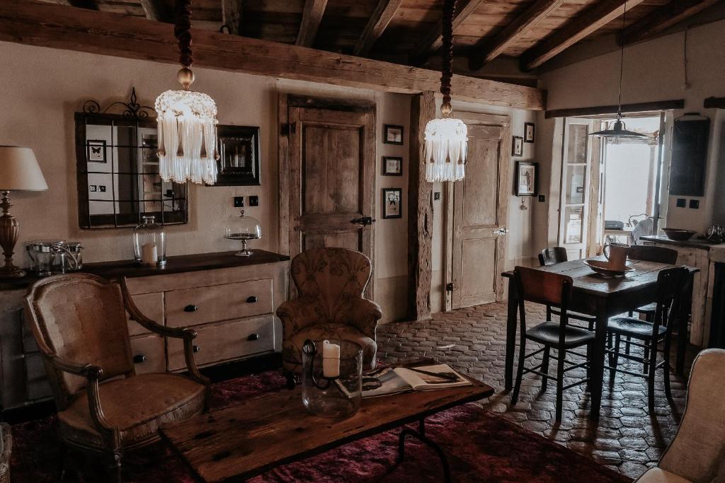 a living room with a table and a dining room at La Casa sopra il Castello - Portovenere in Portovenere