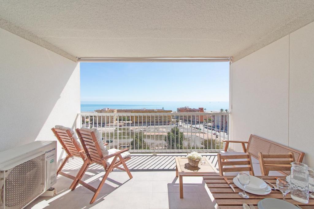 einen Balkon mit Stühlen und Stadtblick in der Unterkunft Global Properties, Moderno apartamento con terraza y vistas al mar in Canet d'en Berenguer