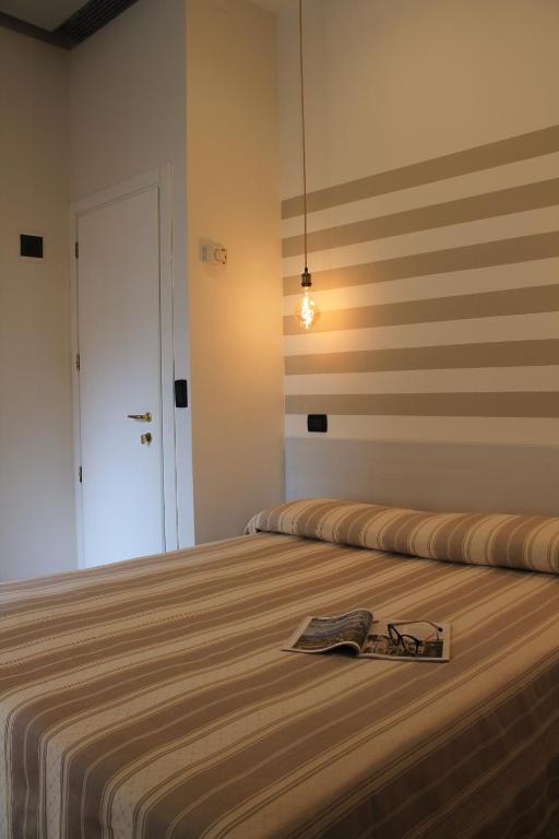 Postel nebo postele na pokoji v ubytování Hotel Piccinelli