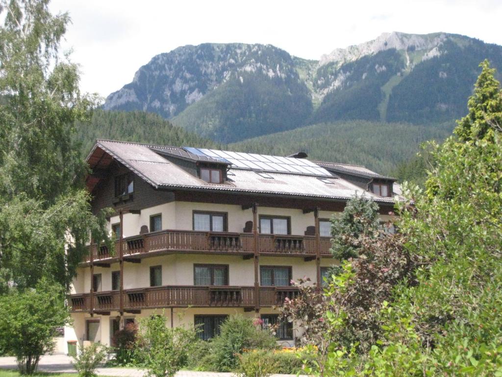 a large building with mountains in the background at Haus Schweighofer in Neuberg an der Mürz